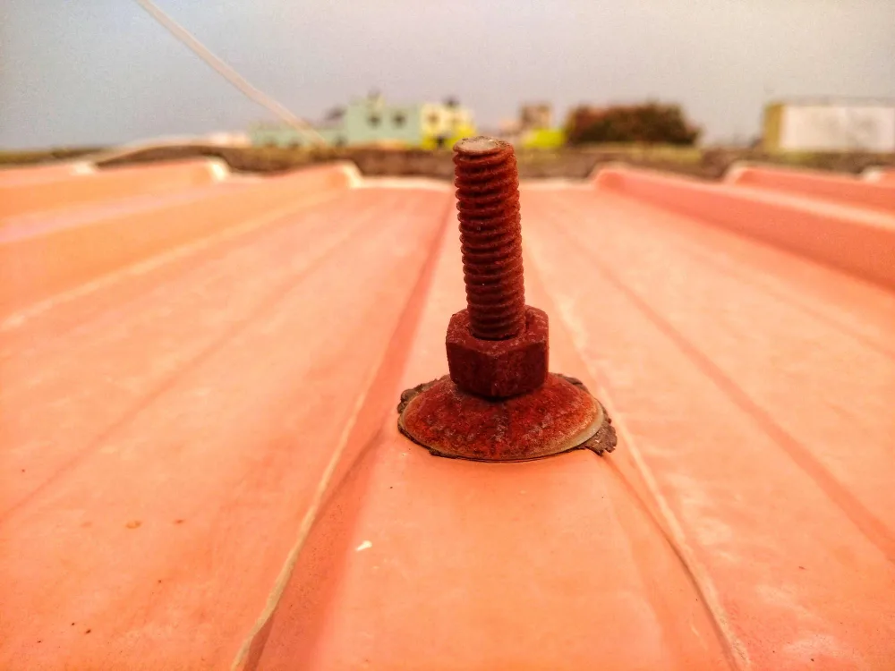 Close-up of a sealed fastener on a metal roof panel