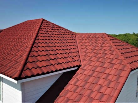 Close view of a red tile-style metal roof gable