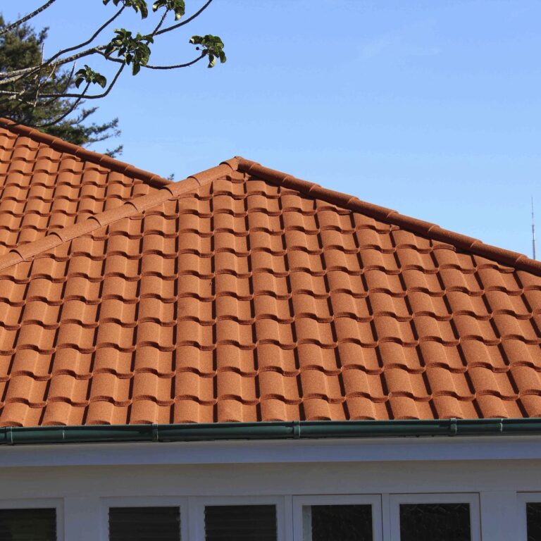 Close-up of a vivid red-orange Spanish and Mediterranean tile-style metal roof, Tilcor Antica style